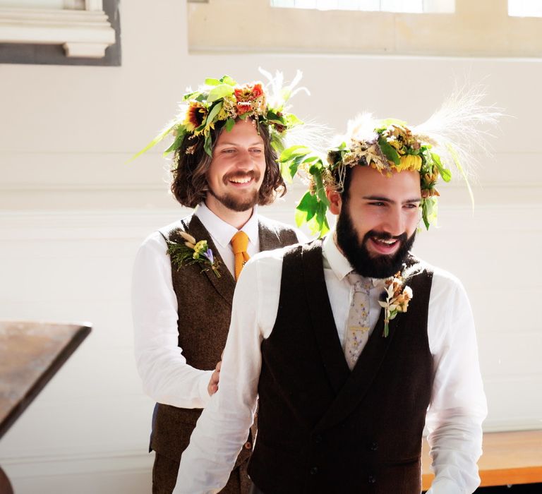 Grooms wear floral crowns complete with brown waistcoats on their wedding day