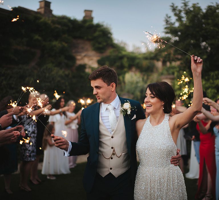 Bride & groom celebrate outdoors with their wedding party on their wedding day