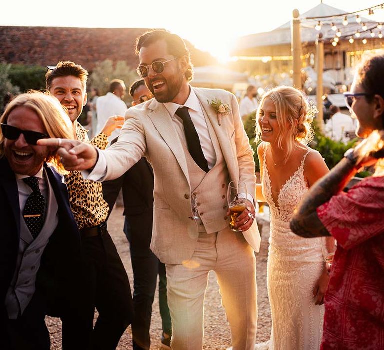 Bride and groom enjoy garden games with friends and family