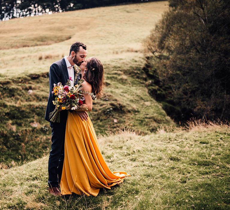 Bride & groom embrace outdoors after ceremony