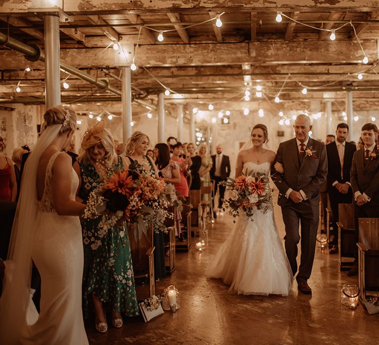 Bride walks down the aisle with her father on wedding day