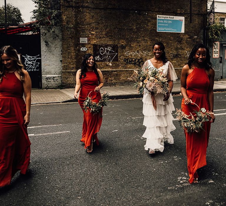 Bridal party in Sienna burnt orange bridesmaid dresses with the bride in Story Of My Dress bespoke bridal separates 