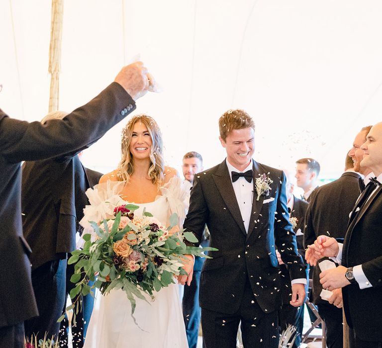 Confetti moment for bride and groom with Halfpenny London wedding dress and large bouquet