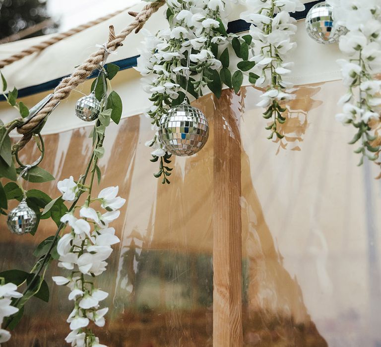 Hanging white wisteria and disco ball decoration for marquee wedding in summer 