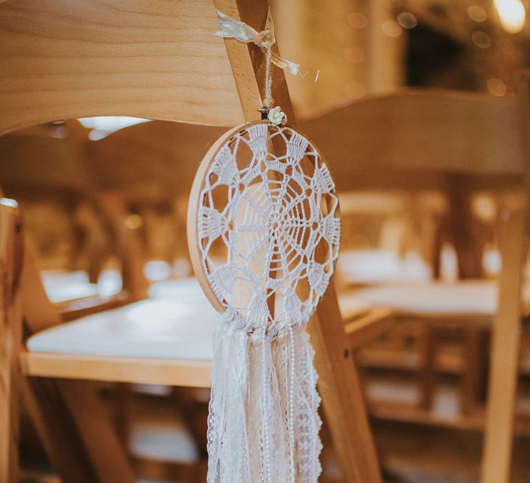 Macrame dream catcher wedding decor on chairs for along the aisle 