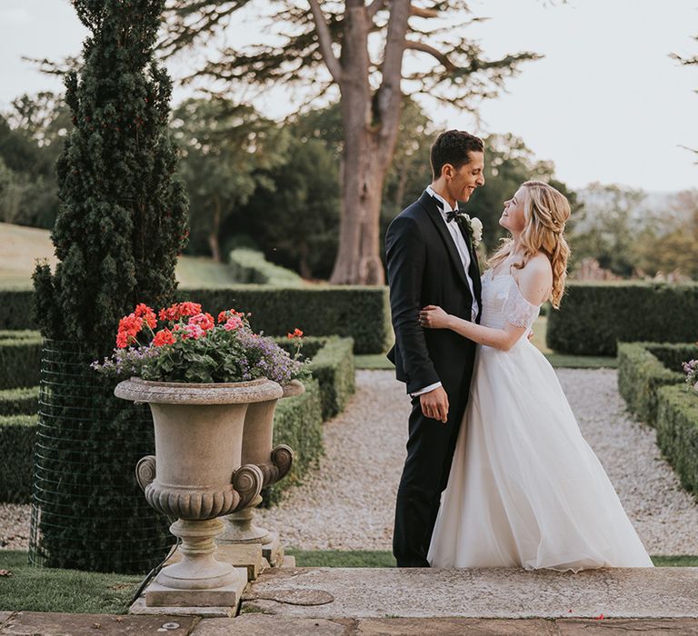 Bride and groom kiss at their country house wedding 