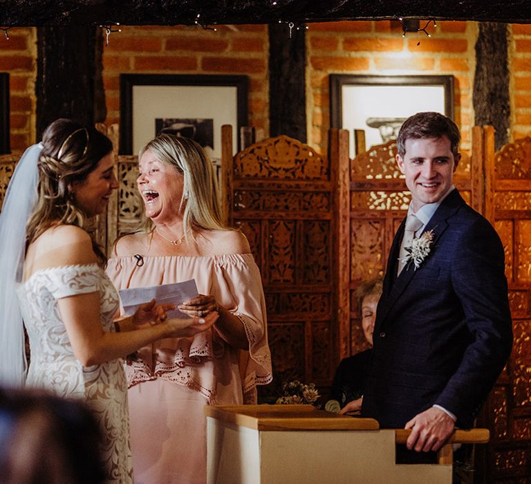 Bride and groom laugh during their wedding ceremony 