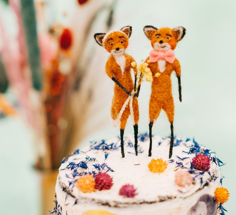 Rustic wedding cake complete with edible florals and two fox cake toppers 