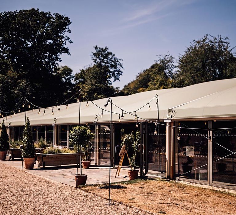 Outdoor wedding marquee with festoon lighting