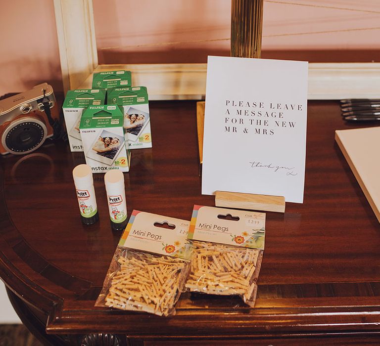 Table set up for Guest Book complete with polaroid camera for personal photos