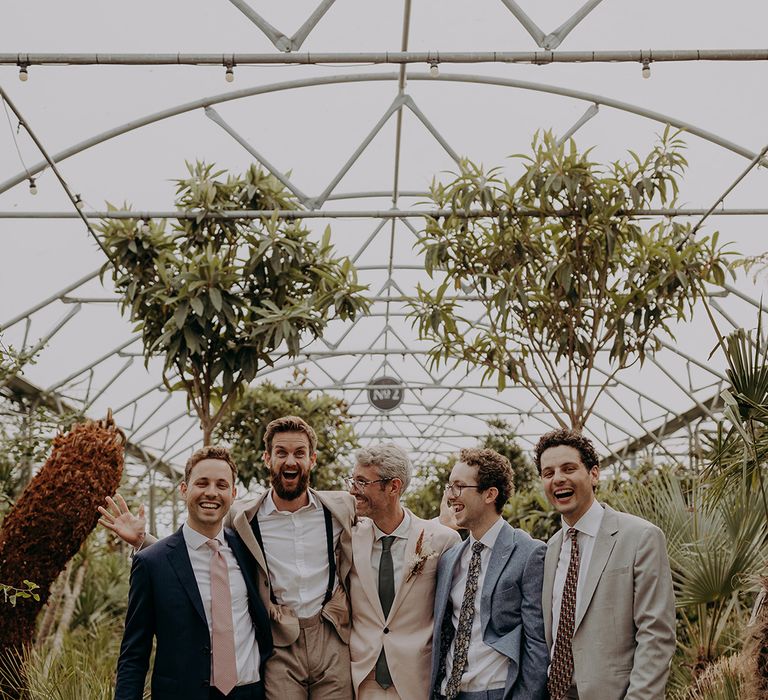 Groomsmen pose for photo in tonal neutral suits