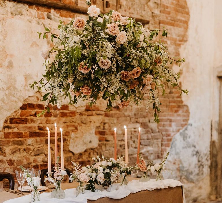 Flower cloud wedding installation with pink and neutral coloured roses with lots of greenery 