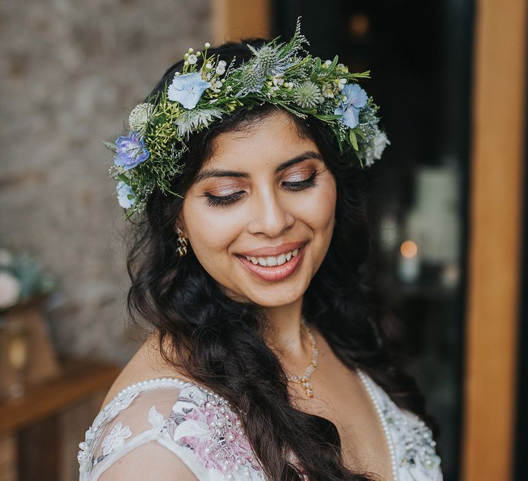 British Indian bride with natural makeup in a floral wedding dress wearing a flower crown 