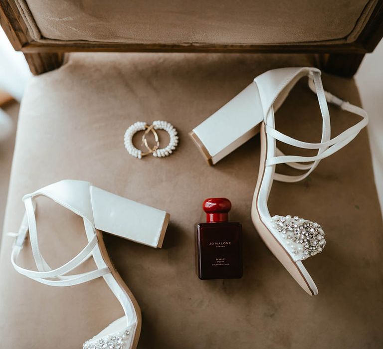 White block heel bridal shoes with jewelled embellishment, pearl earrings and Jo Malone embellishment 