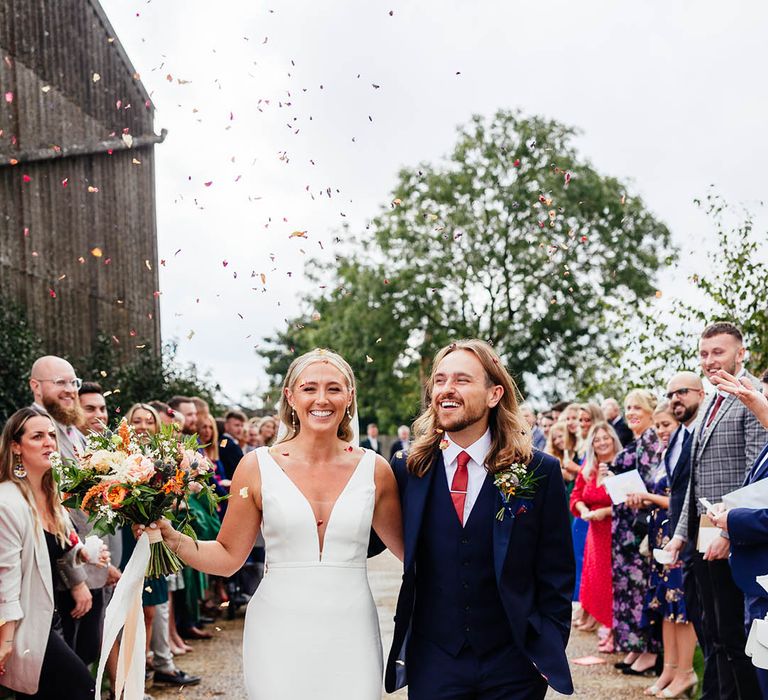 Fun confetti exit for the bride and groom on their wedding day in the South East in Surrey 