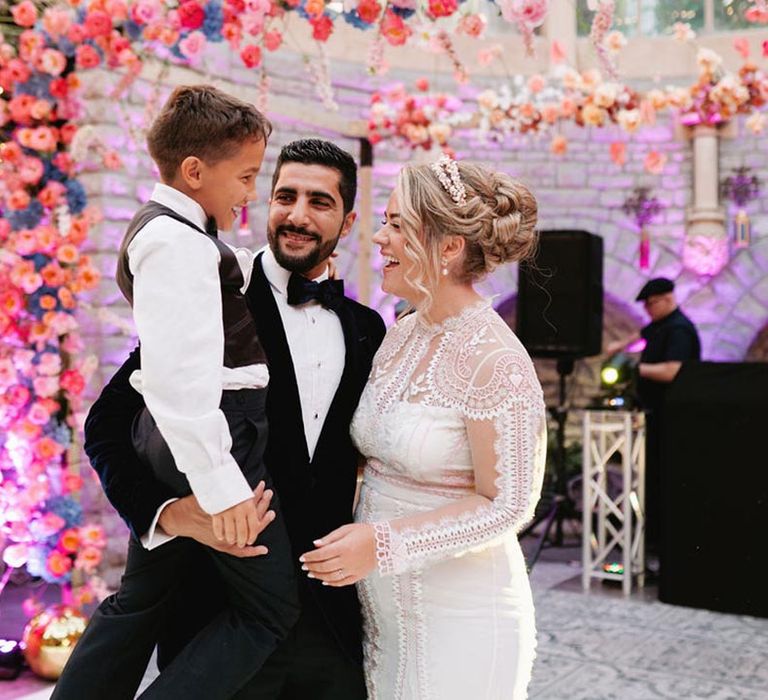 The bride and groom have their first dance with their son 