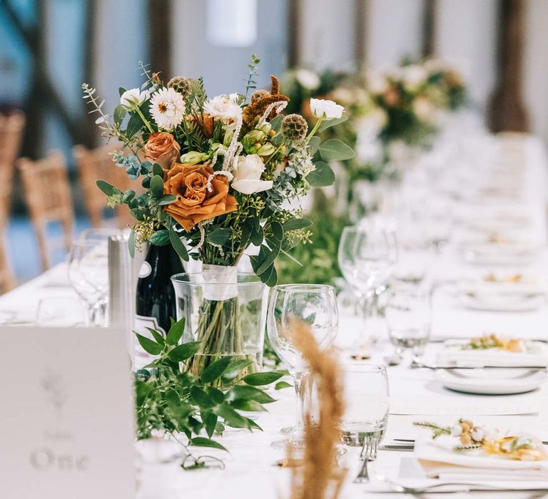 Classic rustic wedding tablescape - white tablecloth, foliage wedding table runners and pampas grass, eucalyptus, blush garden roses, dried flowers and foliage floral centrepieces 