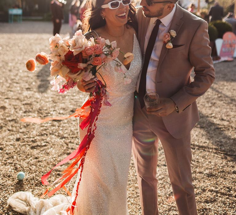 The bride and groom wearing retro sunglasses at stylish wedding 