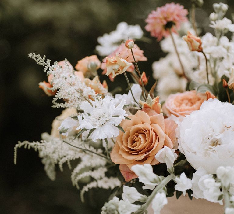 Toffee peach roses with white carnations and flowers 