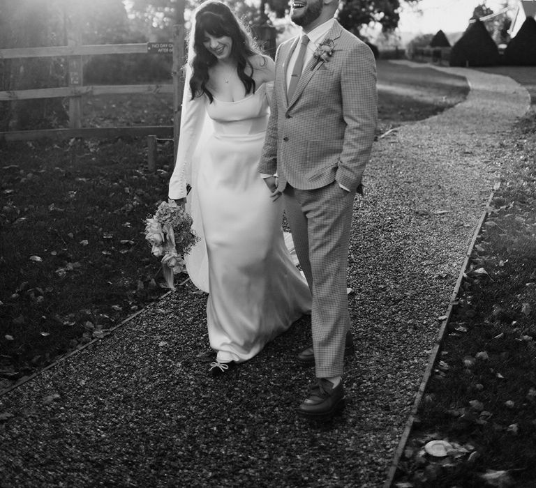 Black and white romantic couple photo of bride in long sleeve off the shoulder wedding dress and groom at Sandon Manor wedding 