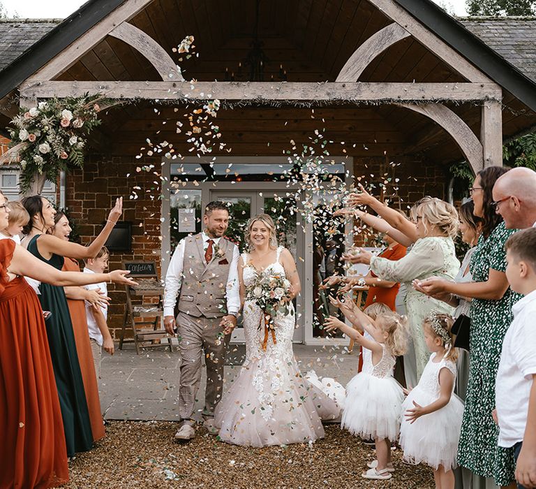 Ash Tree Barns wedding venue with the bride and groom exiting their ceremony 