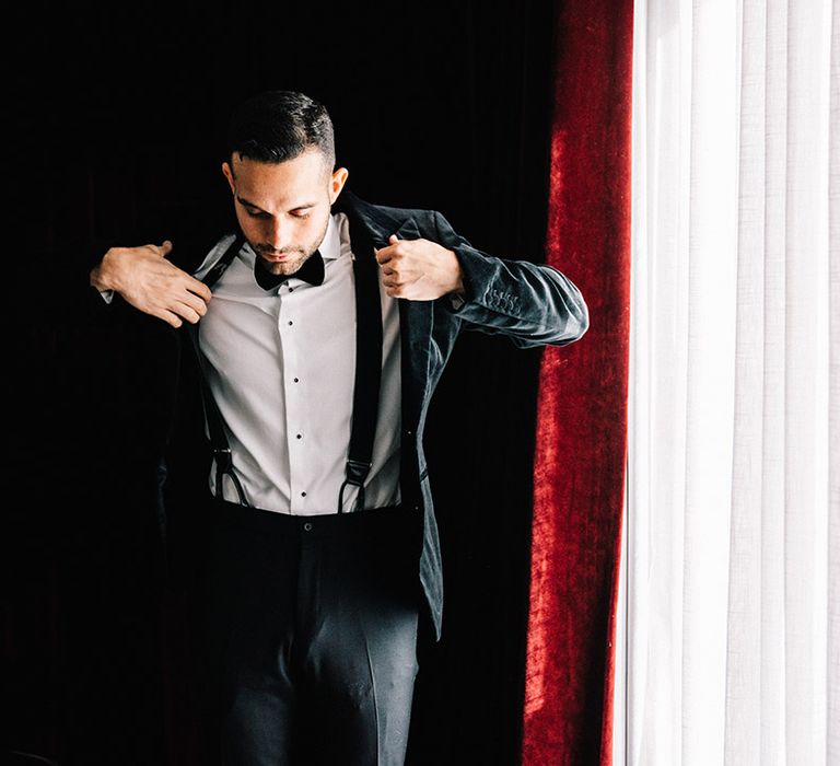 Groom in black tuxedo getting ready for the wedding 