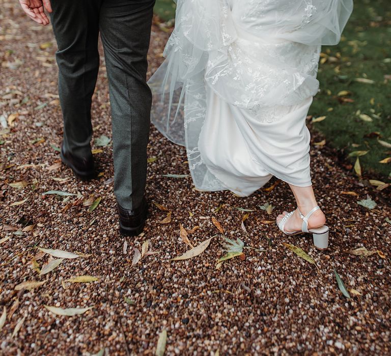 Bride in block heel wedding shoes in lace wedding gown 