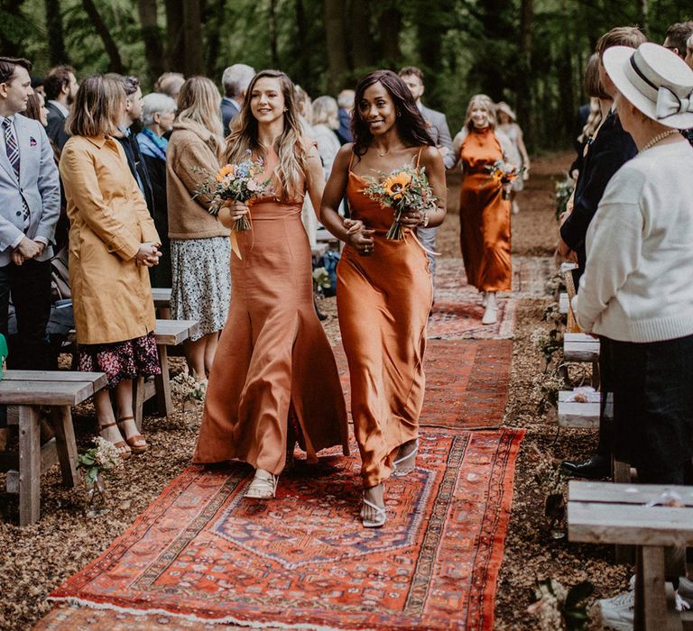 Bridesmaids in burnt orange bridesmaids dresses for spring woodland wedding 