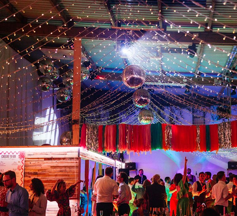 Ash Barton Estate wedding venue decorated with streamers, disco balls and fairy lights