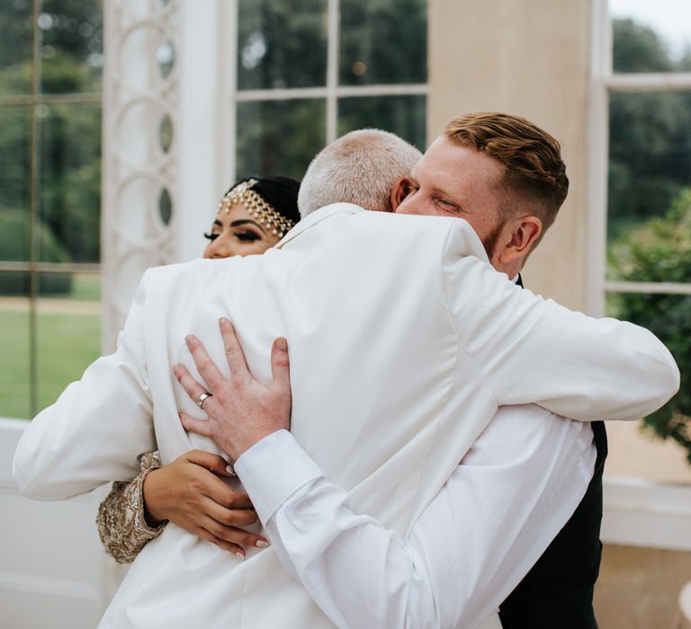 Groom embracing his new father in law