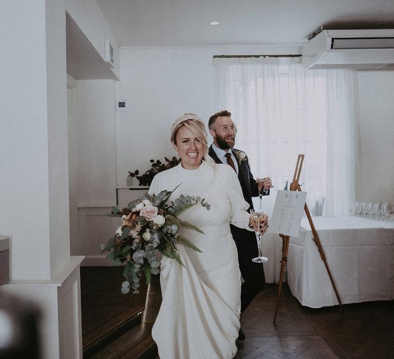 Bride and groom entering the intimate wedding breakfast 