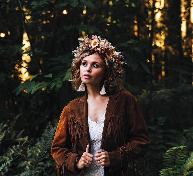 Bride in floral crown and brown suede tassel jacket