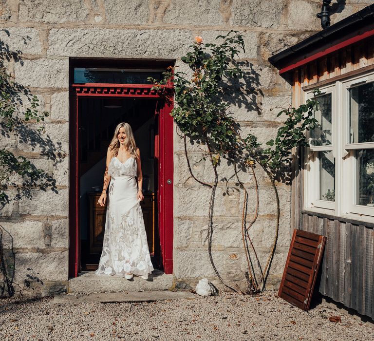 Bride in doorway on the morning of her wedding