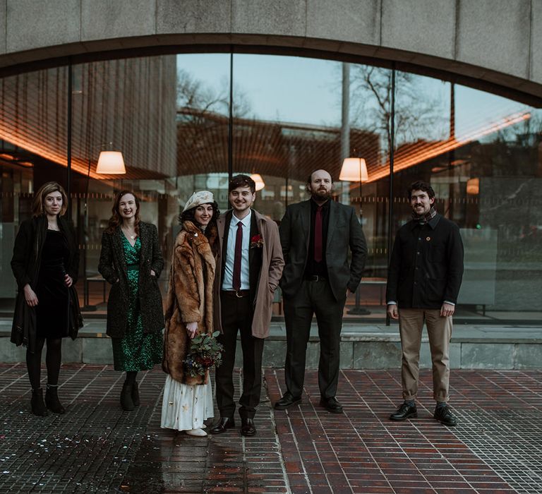 Bride and groom with their closest friends at their Winter elopement