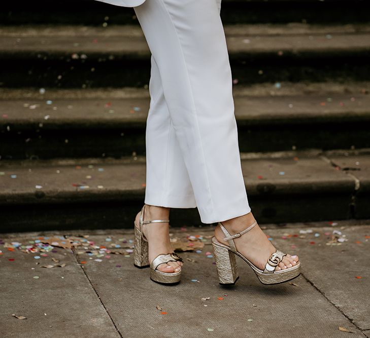 Bride wears Gucci block heel wedding shoes in gold 