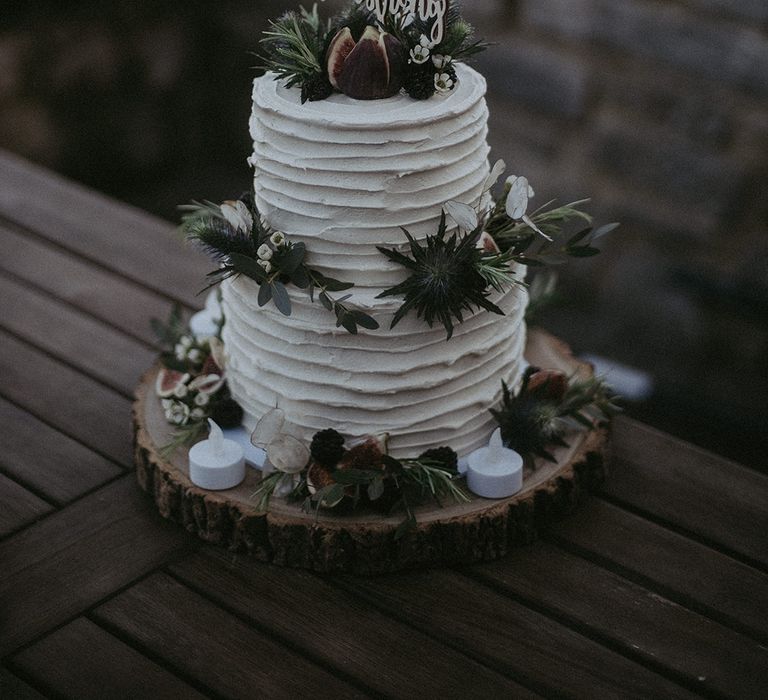 White frosted wedding cake with floral decor 