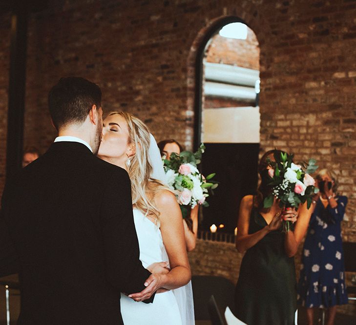 Bride and groom kissing at intimate Gas Street Church wedding 