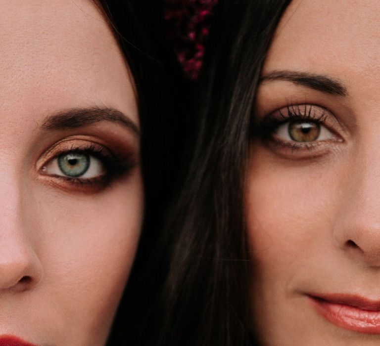 Close up of two brides with golden toned eye makeup