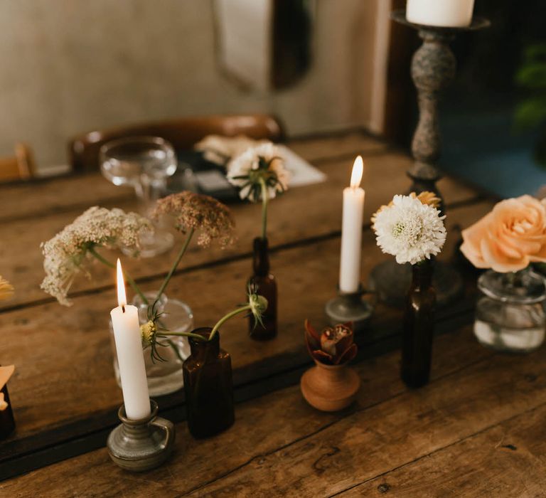 Single flowers in small vases for minimal and neutral tablescape centrepiece details