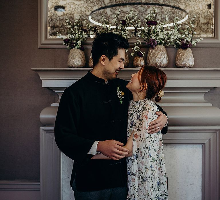 Bride and groom embracing at Old Marylebone Town Hall during their intimate wedding ceremony 