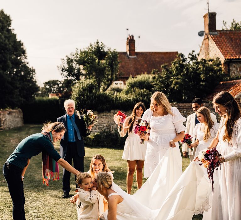 Bride kisses page boy at church wedding