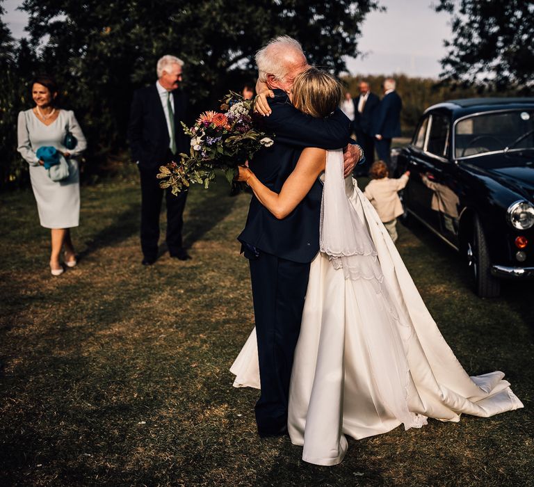 Bride hugs wedding guest at church ceremony