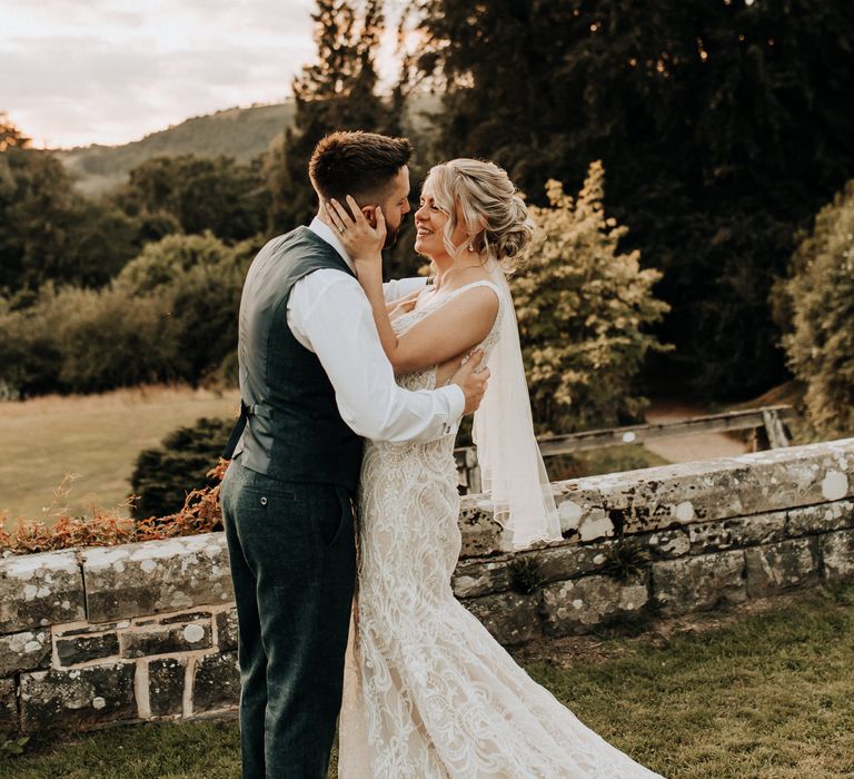 Bride wears Maggie Sottero wedding dress as she shares a moment with groom