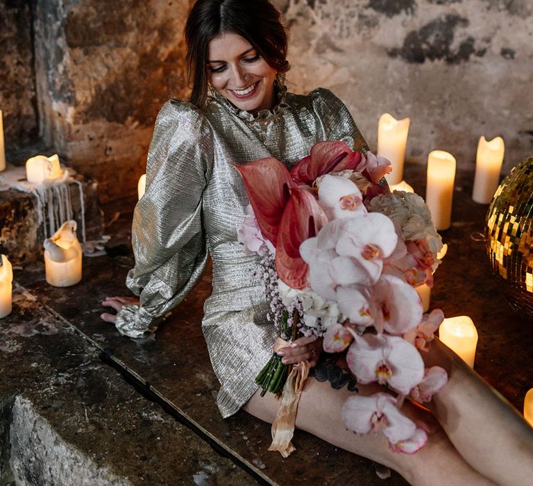 Shimmering puff sleeve dress with candles & calming pink tone bouquet's