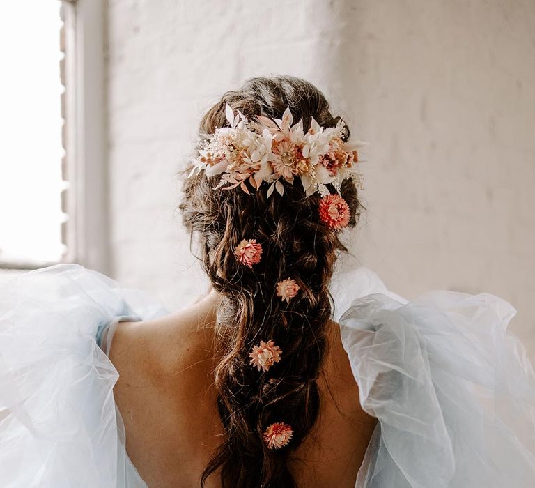 Bride with a braided plait with peach and beige wedding hair comb and individual dry flower hair accessories 