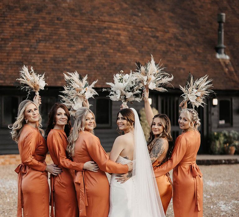 Burnt orange bridesmaid dresses and pampas grass bouquets