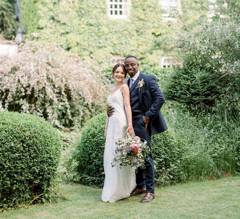 Bride & groom kiss outdoors in the Cotswolds on their wedding day