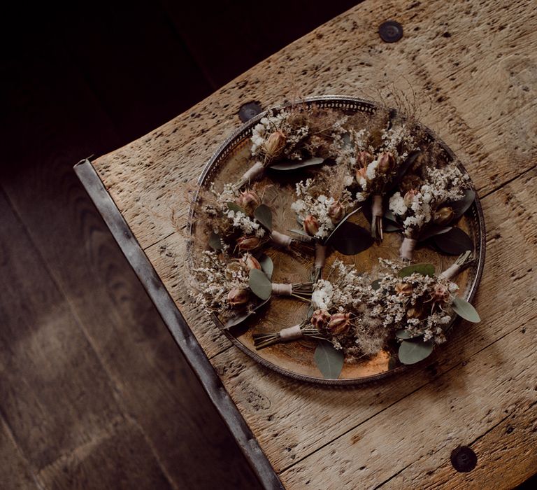 Plate of dried flower buttonholes for groom and groomsmen