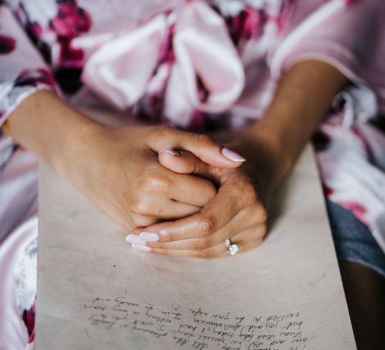 Bride wears french manicured nails on the day of her wedding 