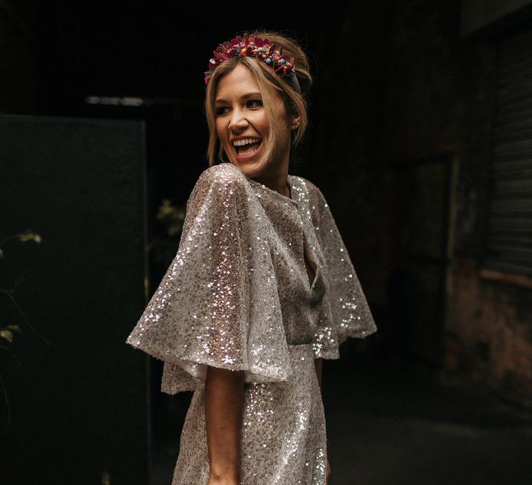 Bride in a sequinned wedding dress with big statement sleeves 